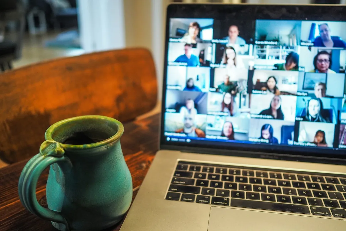 Laptop open on a desk during a remote video meeting